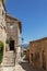 Typical for vernacular architecture buildings, constructions, streets of restored old village Lacoste under blue sky,Â Vaucluse,